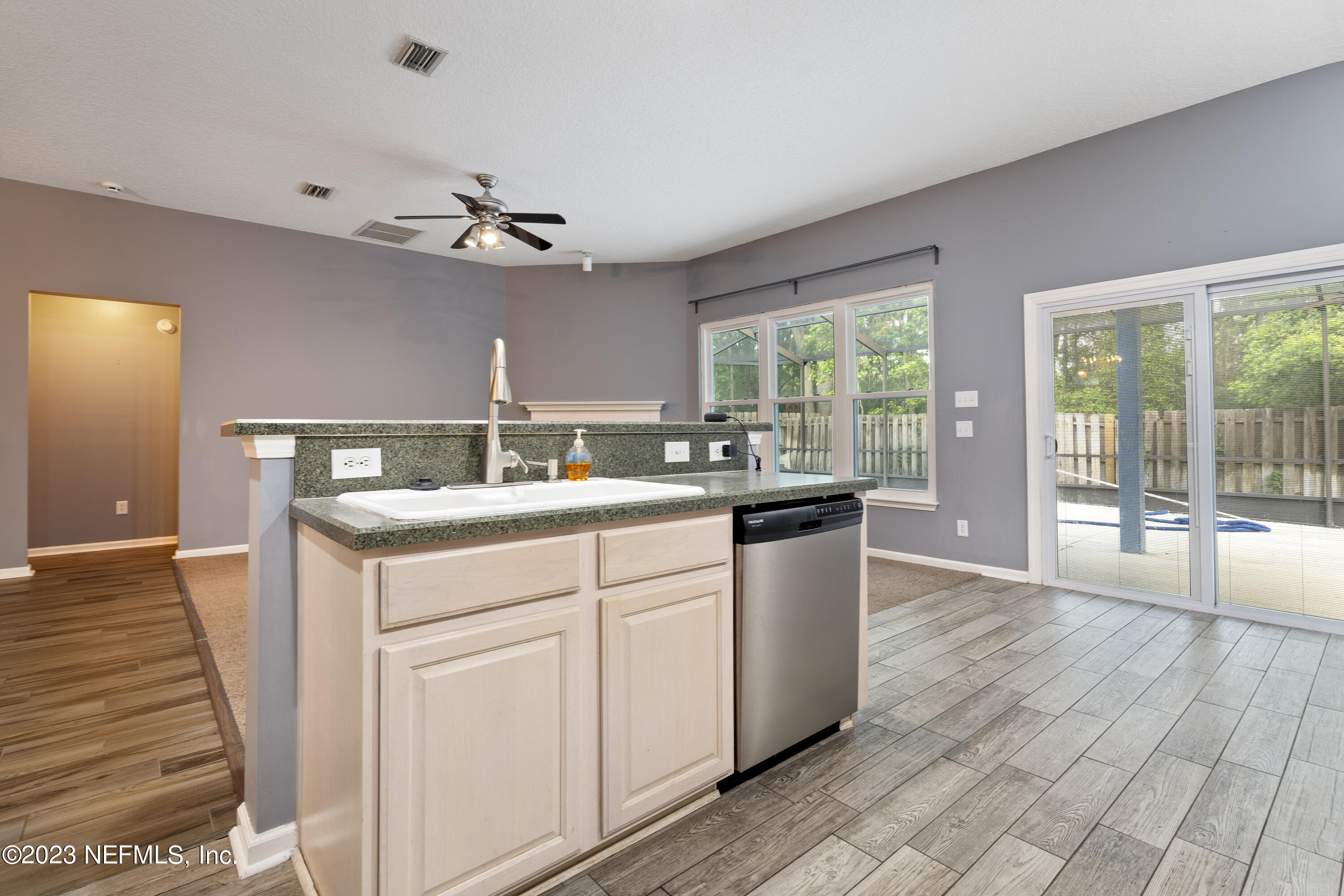 312 West Tropical Trace St. Johns, FL 32259 - Photo 20 of 57 a kitchen with kitchen island granite countertop a sink cabinets and wooden floor