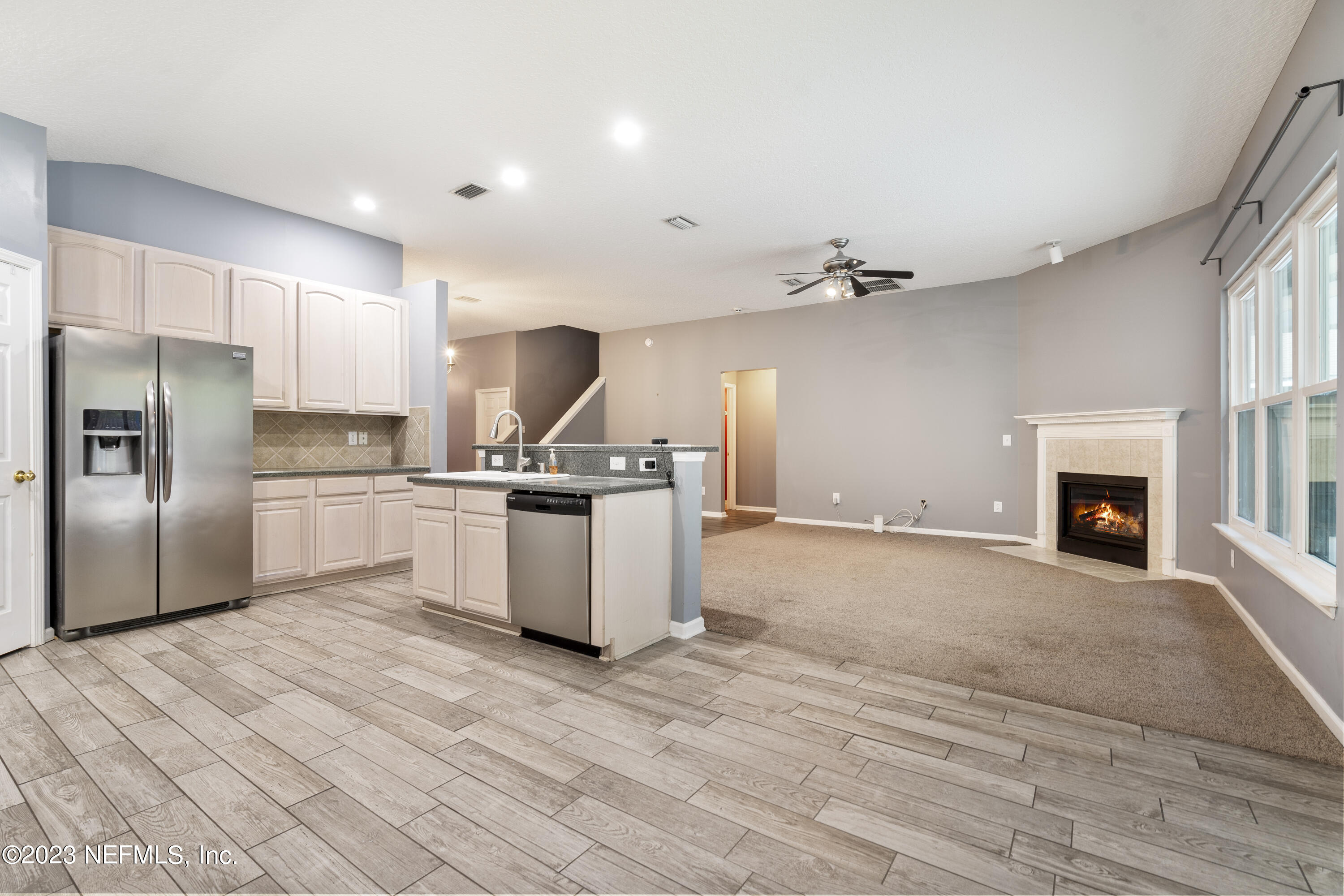 312 West Tropical Trace St. Johns, FL 32259 - Photo 21 of 57 a kitchen with a refrigerator and a fireplace