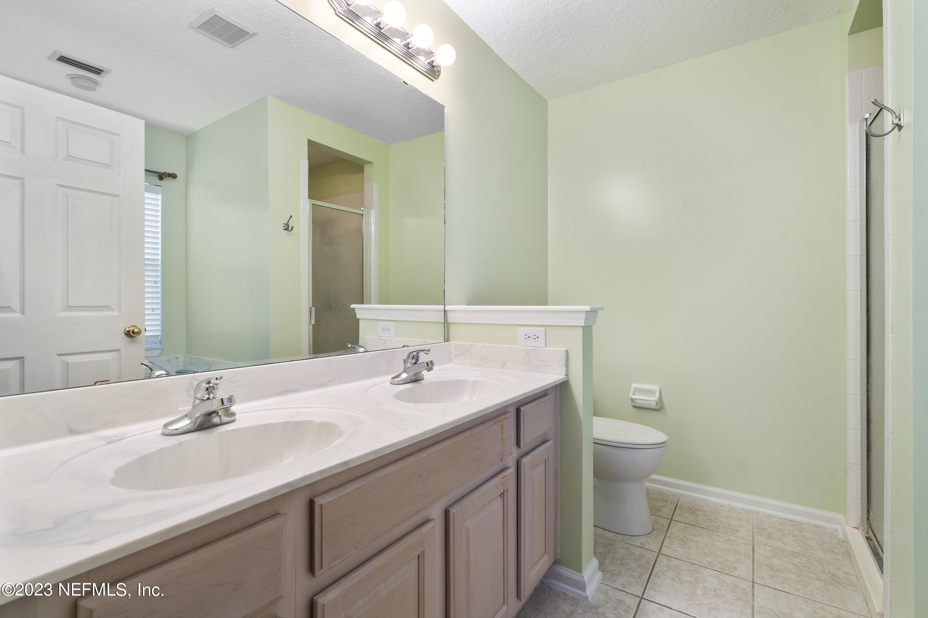 312 West Tropical Trace St. Johns, FL 32259 - Photo 24 of 57 a bathroom with a granite countertop sink a toilet and a mirror