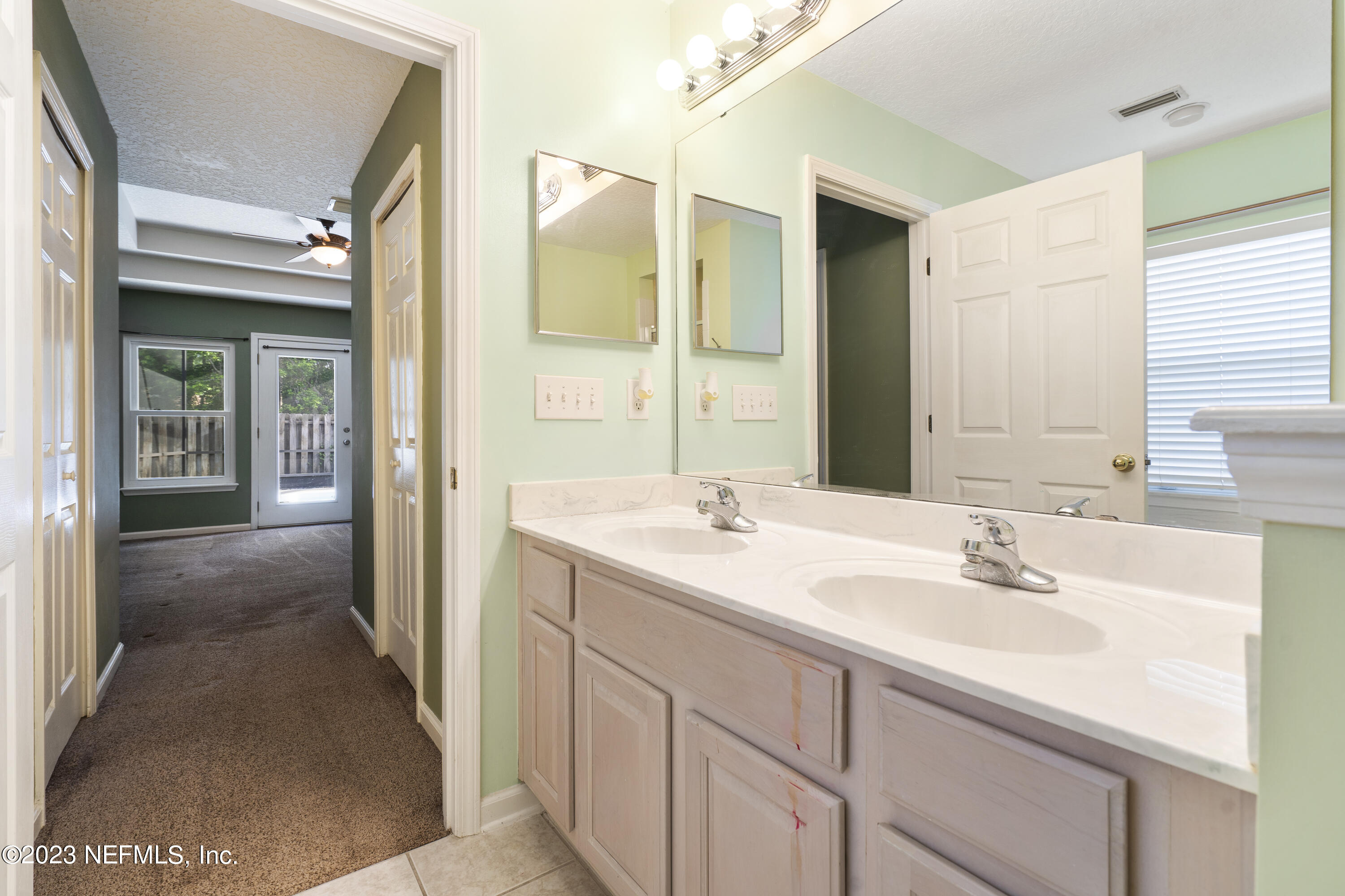 312 West Tropical Trace St. Johns, FL 32259 - Photo 26 of 57 a bathroom with a sink and a mirror