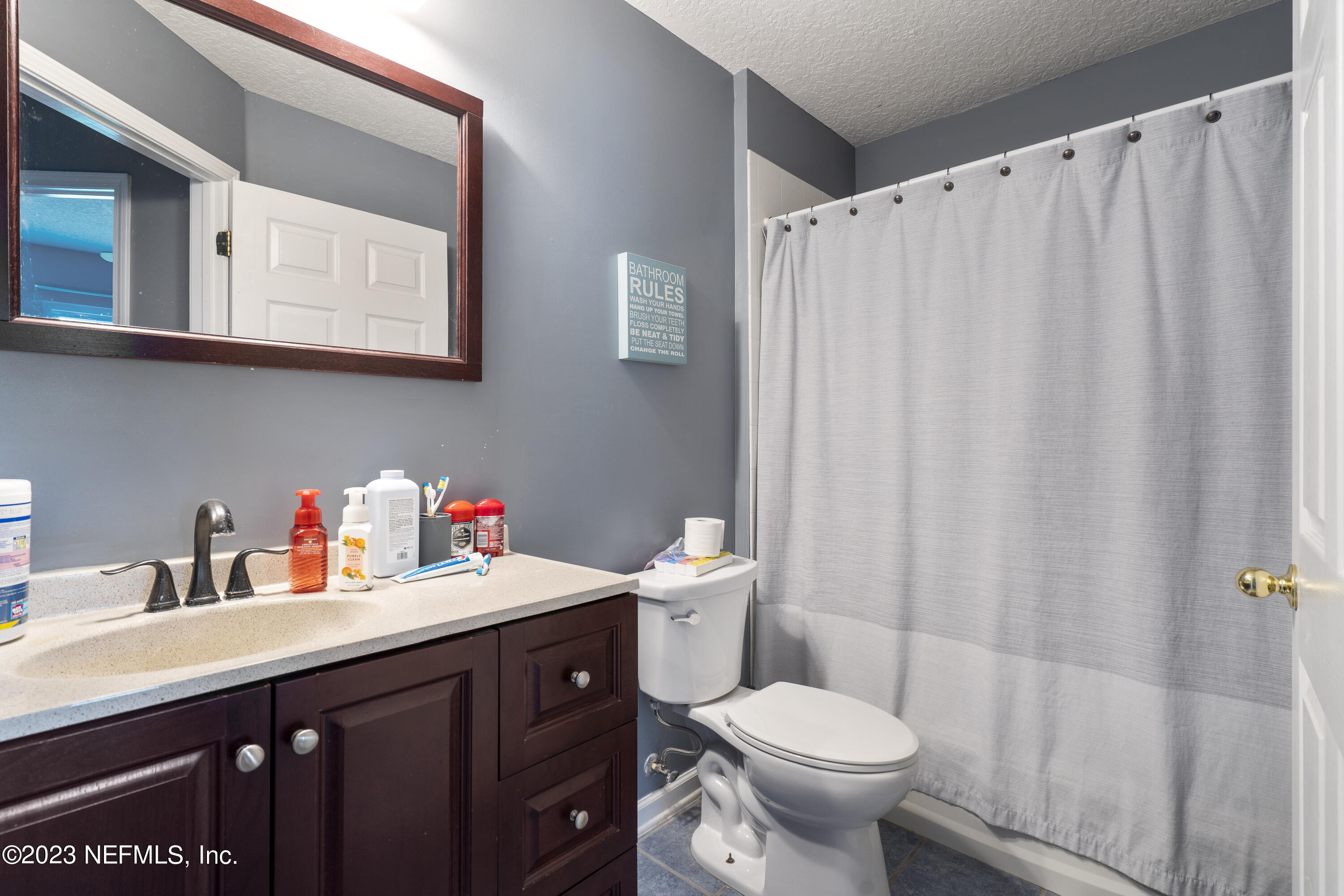 312 West Tropical Trace St. Johns, FL 32259 - Photo 31 of 57 a bathroom with a sink a toilet and shower curtain