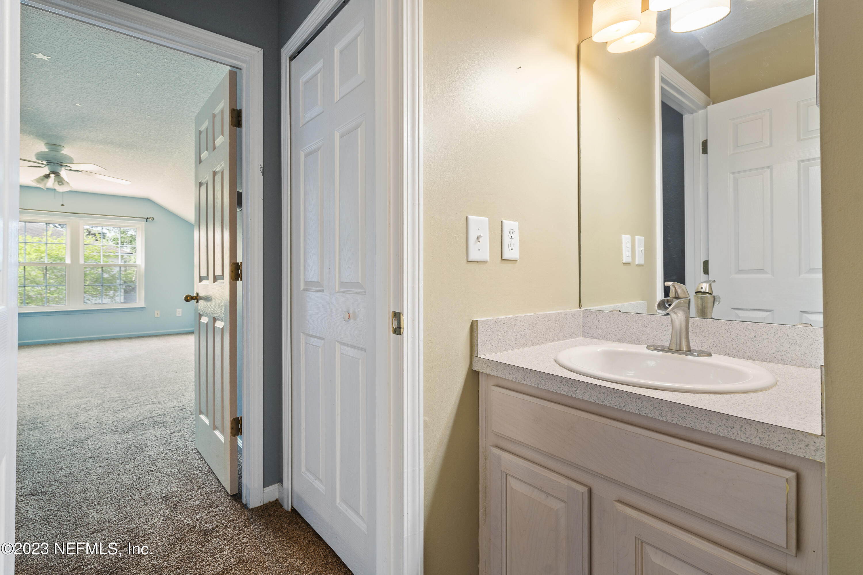 312 West Tropical Trace St. Johns, FL 32259 - Photo 35 of 57 a bathroom with a sink and a mirror
