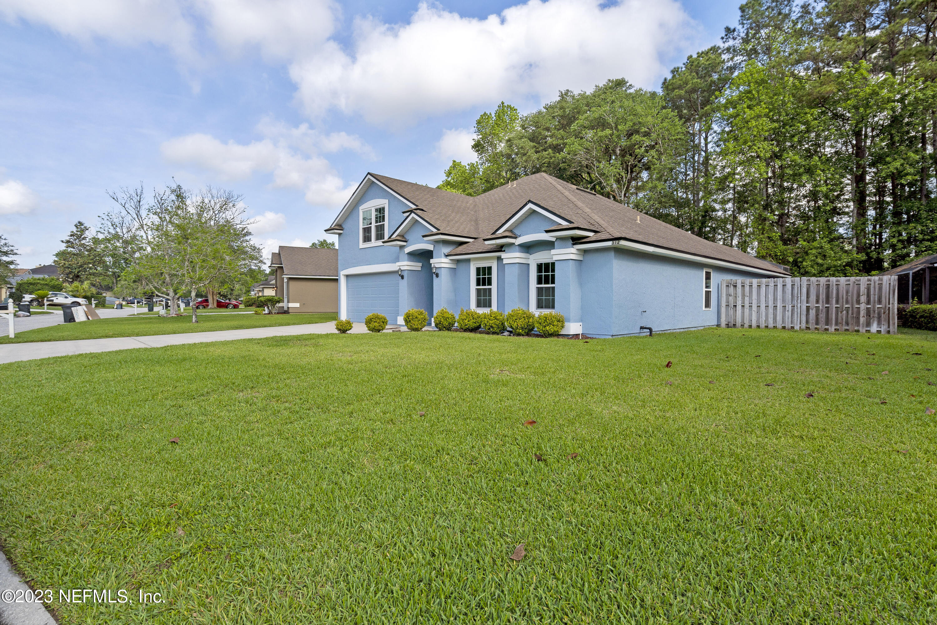 312 West Tropical Trace St. Johns, FL 32259 - Photo 4 of 57 a front view of a house with garden