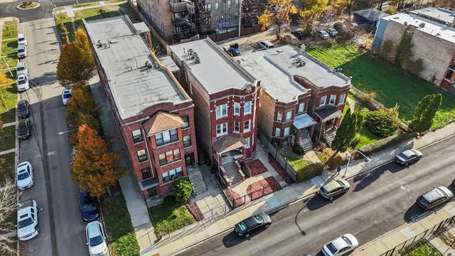 an aerial view of a residential apartment building with a yard