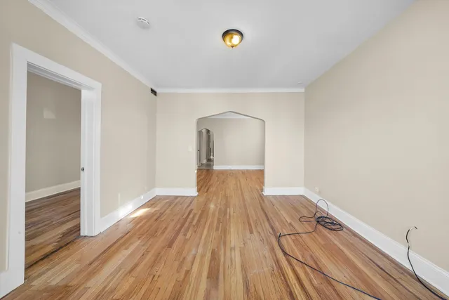 a view of a room with wooden floor and white walls