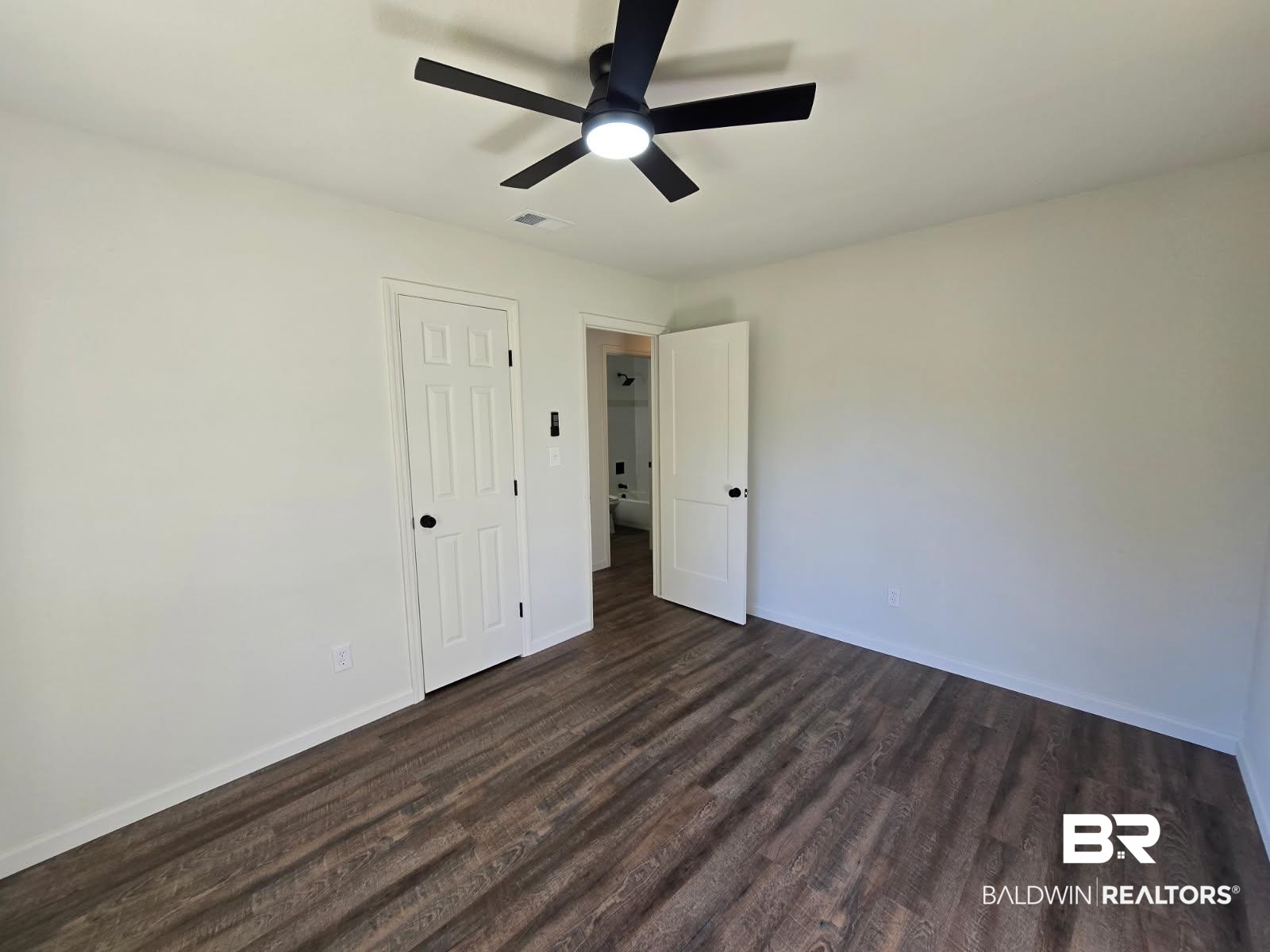1404 Dailey Street Brewton, AL 36426 - Photo 19 of 25 Unfurnished bedroom featuring dark wood-style floors and ceiling fan
