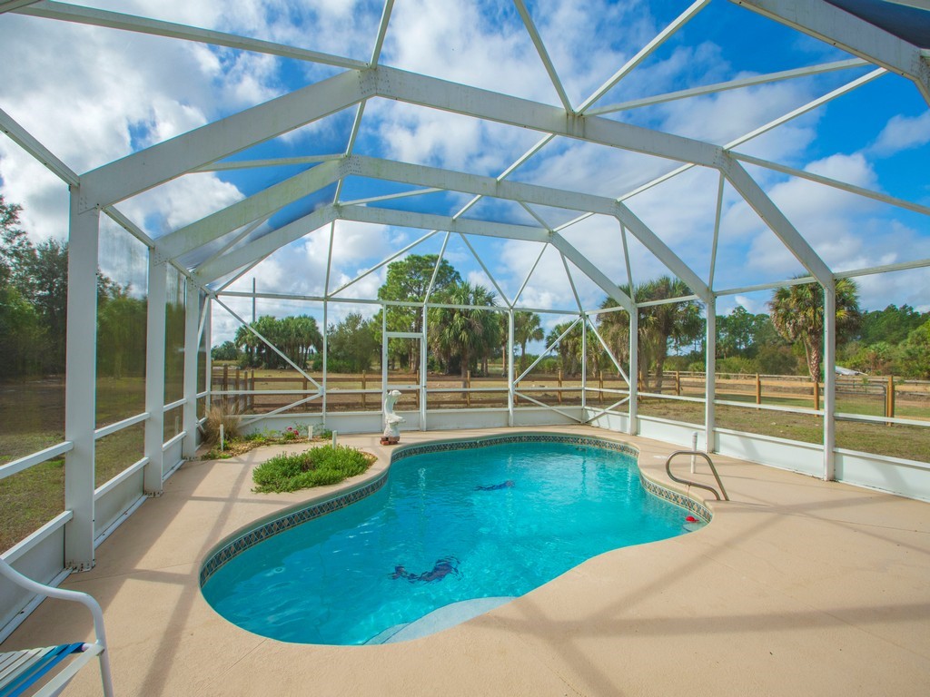 167 Deer Run Road Palm Bay, FL 32909 - Photo 30 of 35 a view of a swimming pool with a yard