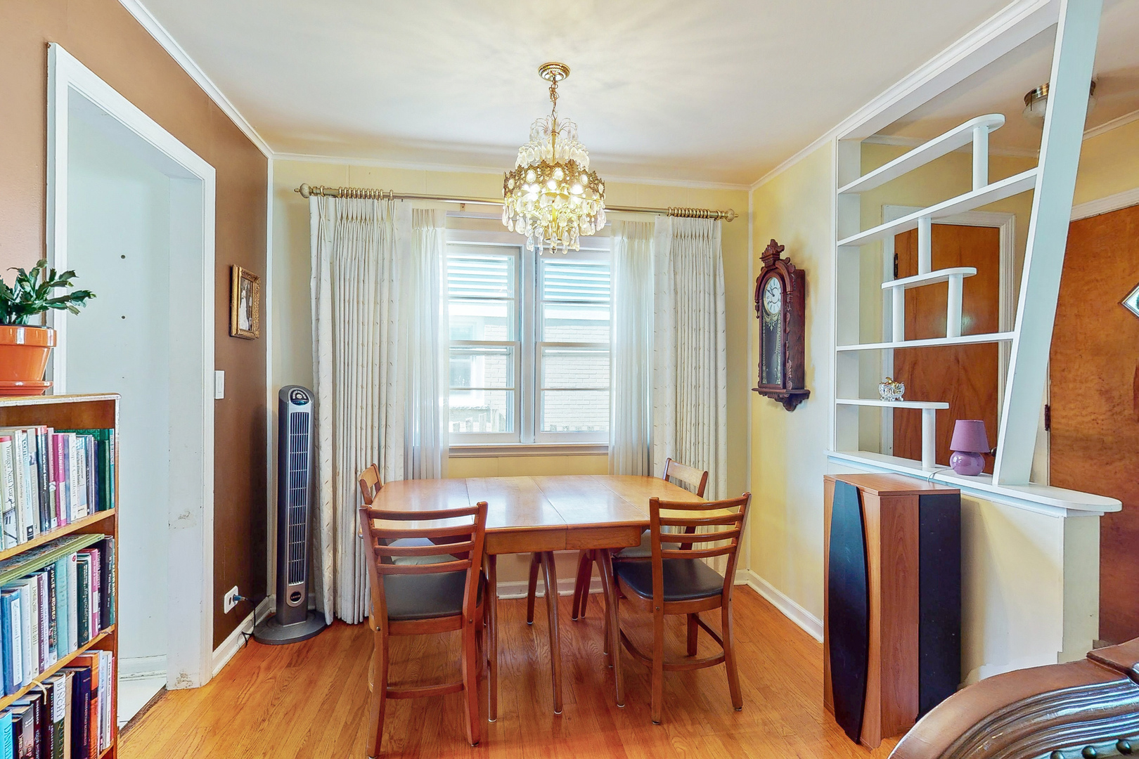 1305 Wayne Drive Des Plaines, IL 60018 - Photo 4 of 25 a view of a dining room with furniture and a book shelf
