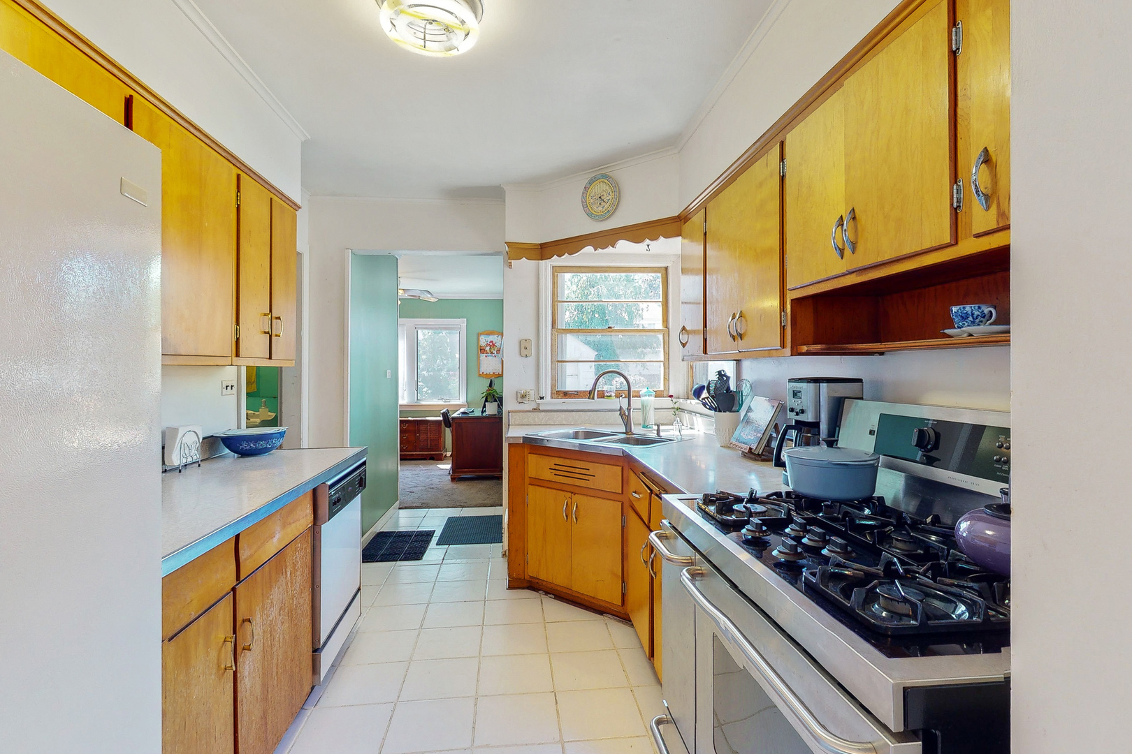 1305 Wayne Drive Des Plaines, IL 60018 - Photo 6 of 25 a kitchen with stainless steel appliances granite countertop a stove a sink and a microwave