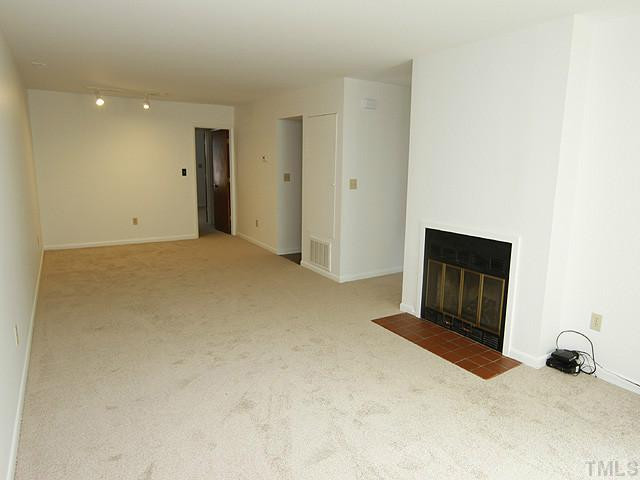 816 Berkeley Street, Unit B Durham, NC 27705 - Photo 2 of 12 a bedroom with a bed and a dresser