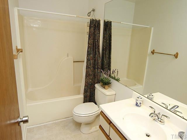 816 Berkeley Street, Unit B Durham, NC 27705 - Photo 8 of 12 a bathroom with a sink a toilet and shower
