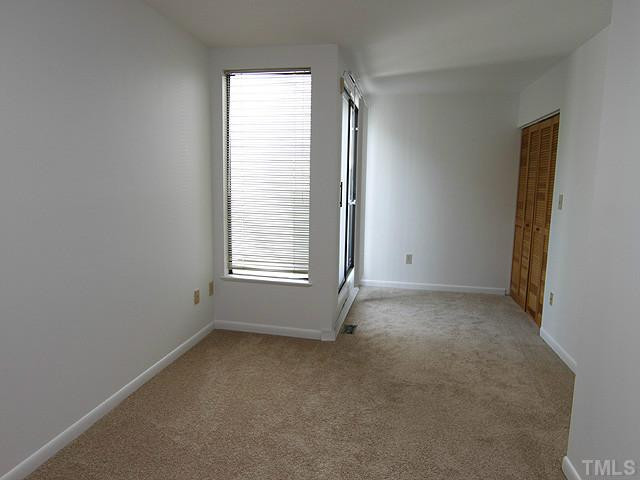 816 Berkeley Street, Unit B Durham, NC 27705 - Photo 9 of 12 an empty room with windows