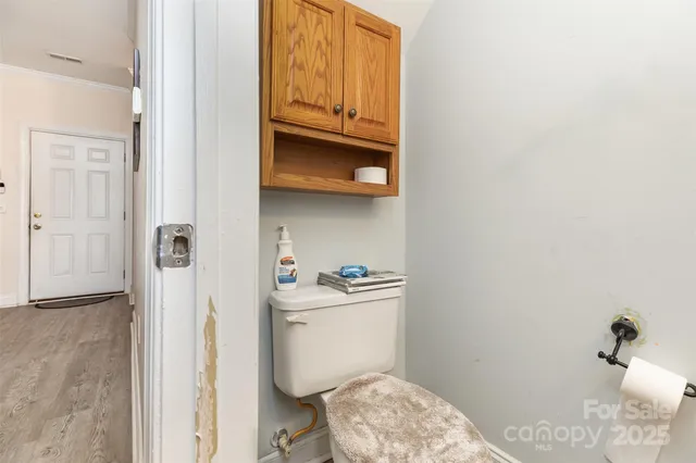 a bathroom with a granite countertop toilet and a sink