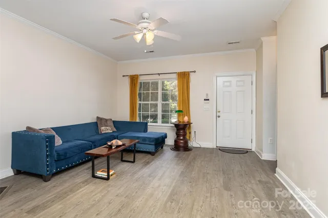 a living room with furniture and a chandelier