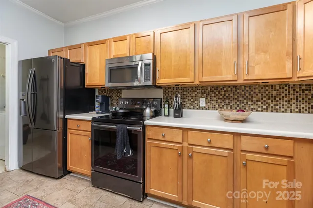 a kitchen with stainless steel appliances granite countertop a refrigerator and a sink