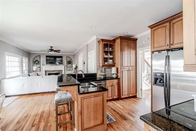 a kitchen with stainless steel appliances granite countertop a refrigerator stove oven a sink and dishwasher