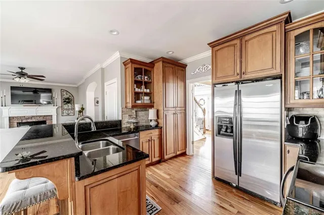 a kitchen with granite countertop a sink and a stove top oven