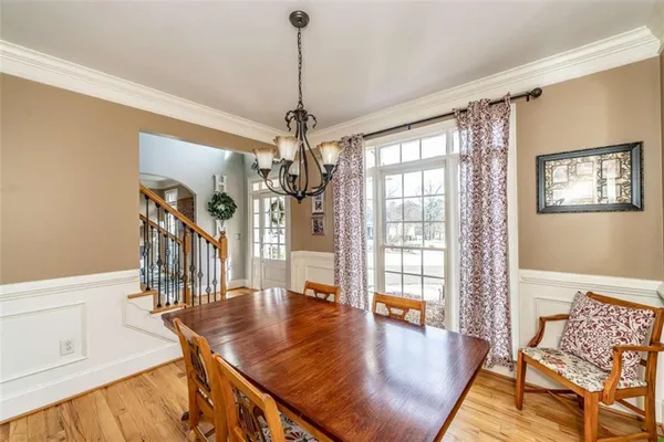 a living room with a table and chairs