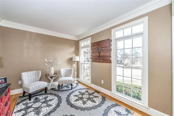 a living room with furniture a rug and a chandelier