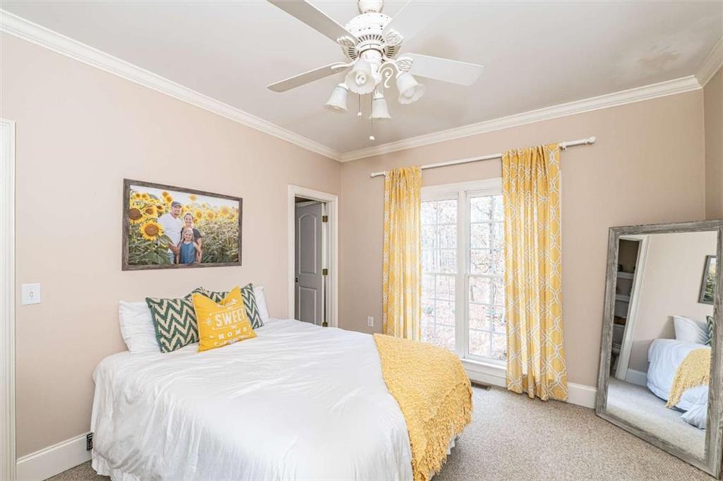 15 Quarter Horse Drive Northwest Rome, GA 30165 - Photo 23 of 57 a bedroom with a bed and a chandelier