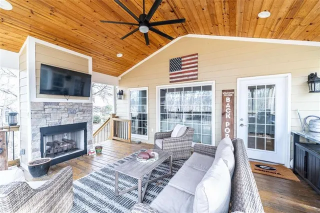 a view of a hallway to a livingroom with furniture and stairs