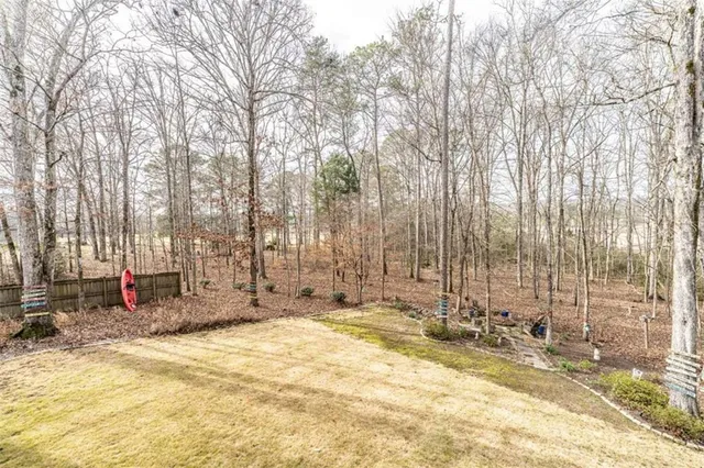 a spacious bedroom with a bed and a chandelier