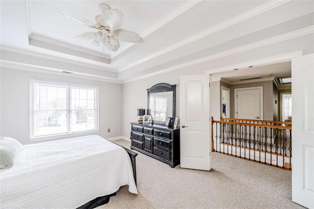 15 Quarter Horse Drive Northwest Rome, GA 30165 - Photo 33 of 57 a spacious bedroom with a bed and a chandelier