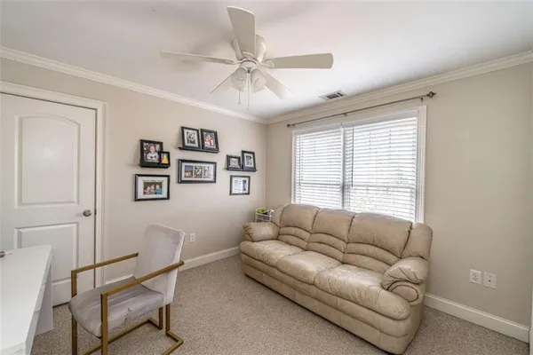 a view of a livingroom with workspace and a window