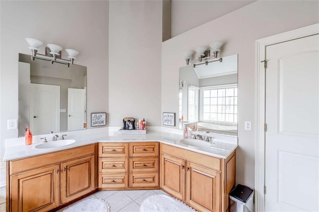15 Quarter Horse Drive Northwest Rome, GA 30165 - Photo 36 of 57 a spacious bathroom with double vanity sink a two mirror a window and a bathtub
