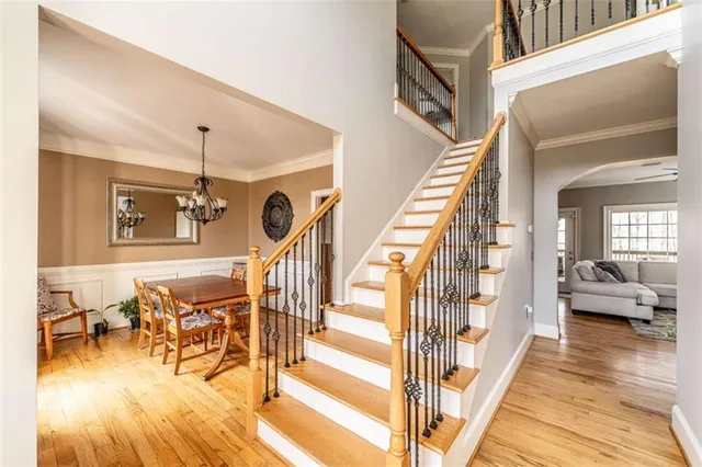 a view of a livingroom with wooden floor and furniture