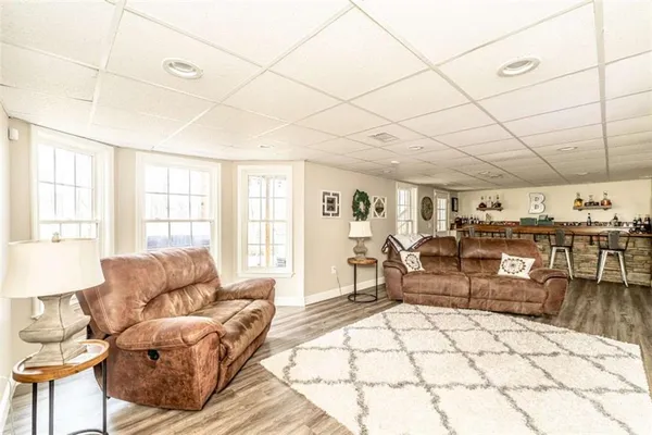 a living room with furniture a wooden floor and a window