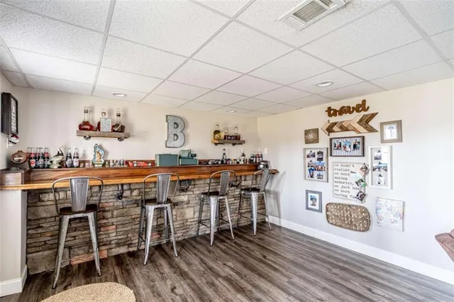 a bathroom with a granite countertop toilet and a sink