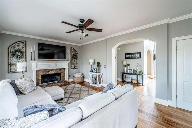 a living room with furniture a fireplace and a flat screen tv