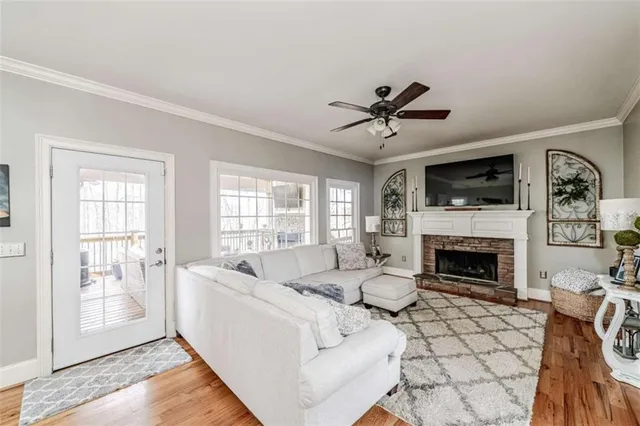a living room with furniture fireplace and window