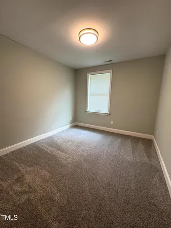 an empty room with a empty space and windows