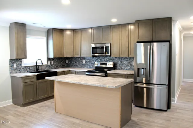 a kitchen with a refrigerator sink and microwave
