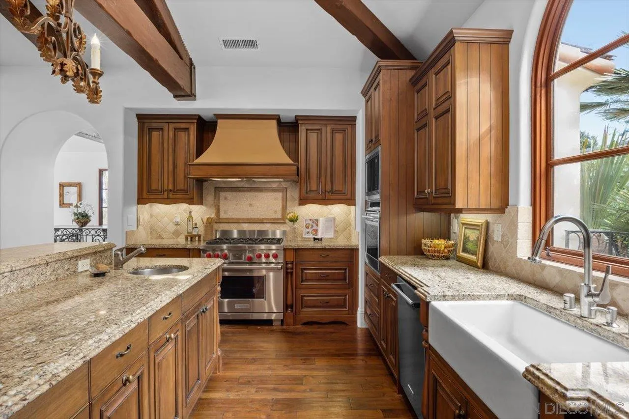 1646 Kearsarge Road La Jolla, CA 92037 - Photo 14 of 35 a kitchen with stainless steel appliances granite countertop a sink stove and cabinets