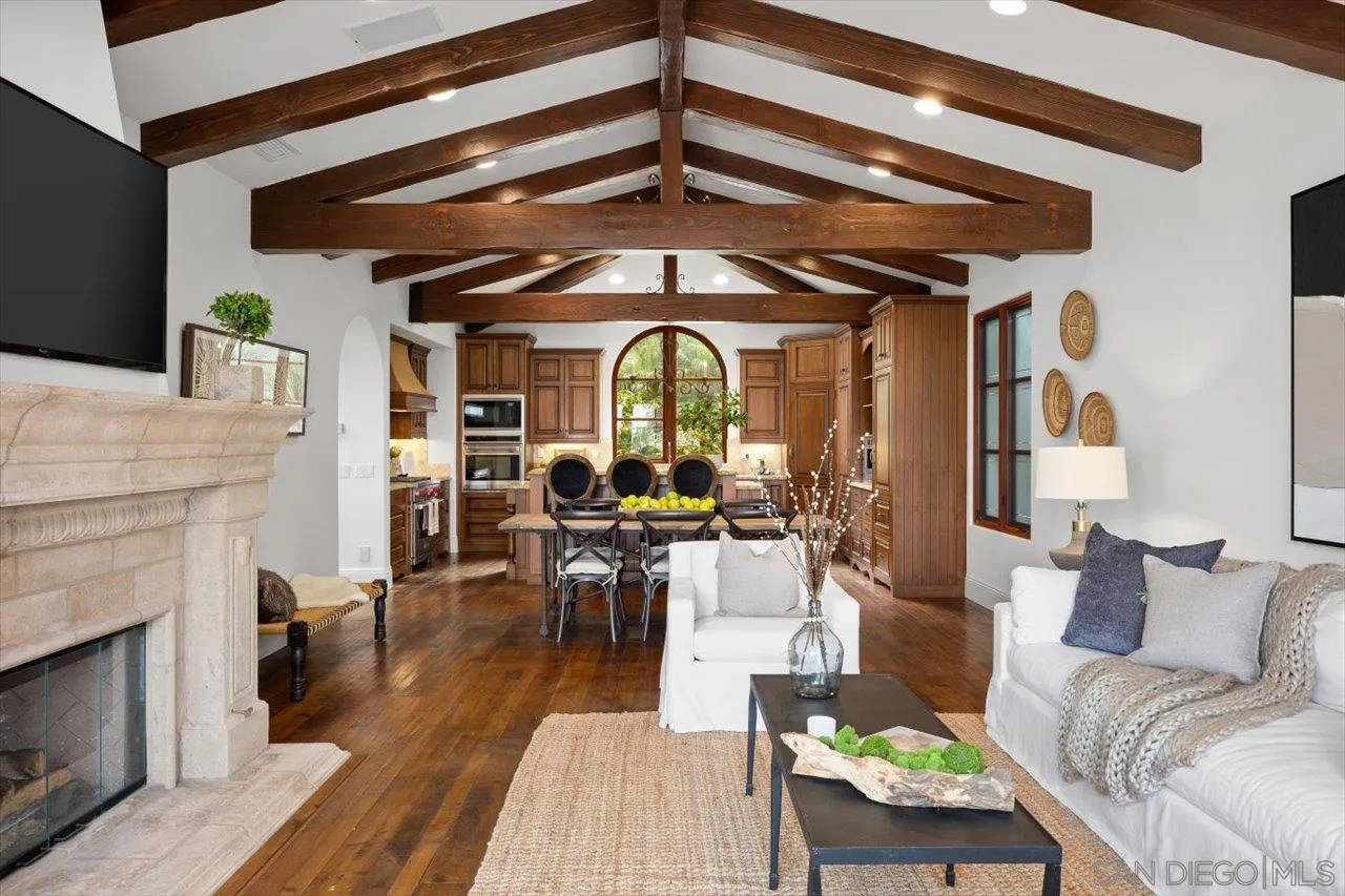 1646 Kearsarge Road La Jolla, CA 92037 - Photo 2 of 35 a living room with furniture a fireplace and wooden floor