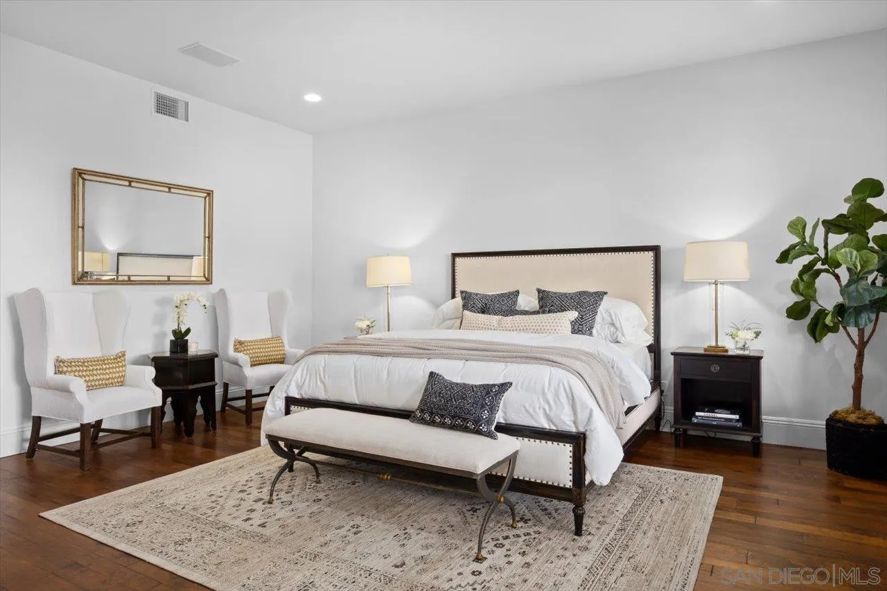 1646 Kearsarge Road La Jolla, CA 92037 - Photo 24 of 35 a bedroom with a bed a table and a potted plant