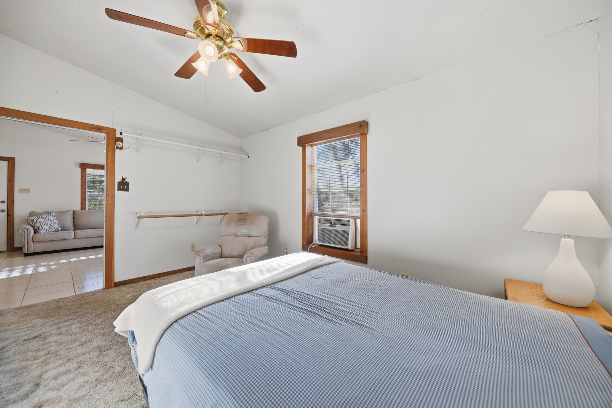 100 Choctaw Crest Somerville, TX 77879 - Photo 15 of 26 a bedroom with a bed and a chandelier