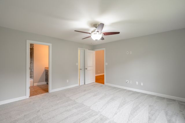 a view of an empty room with a ceiling fan