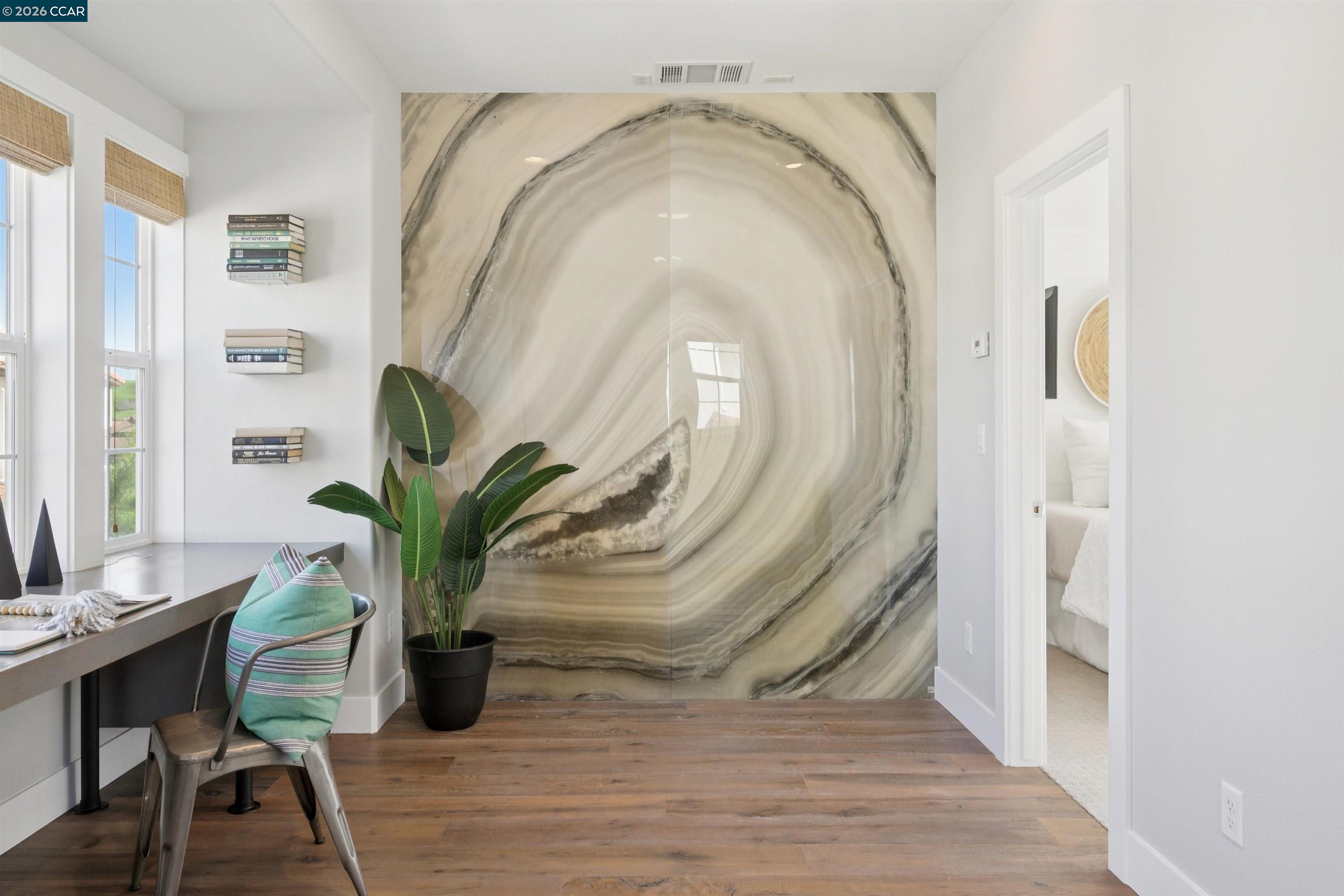 5162 Rowan Drive San Ramon, CA 94582 - Photo 43 of 57 a view of a hallway with wooden floor and a potted plant