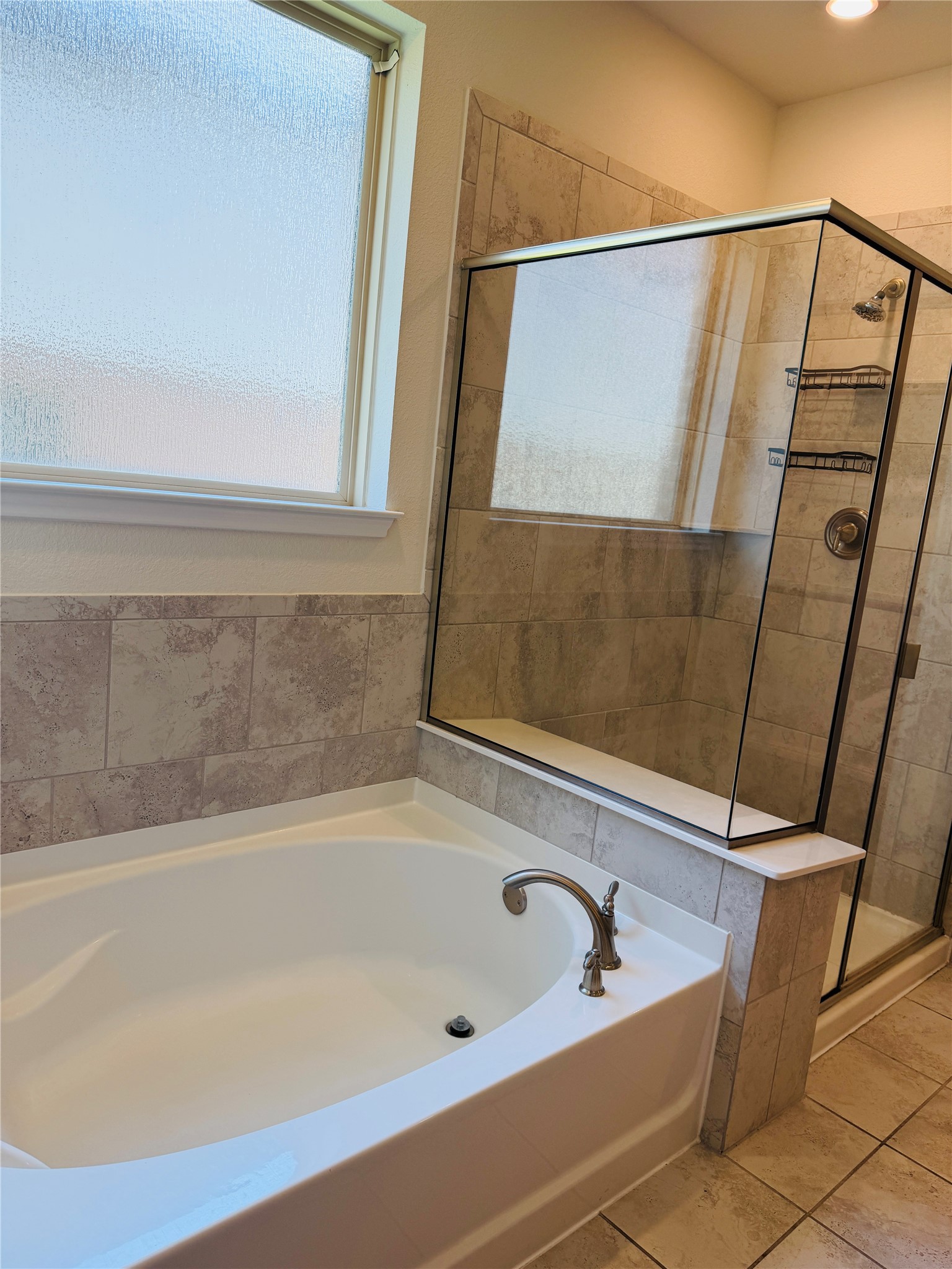 2013 Hat Bender Loop Round Rock, TX 78664 - Photo 12 of 16 Full bathroom with a garden tub, a shower stall, and light tile patterned floors