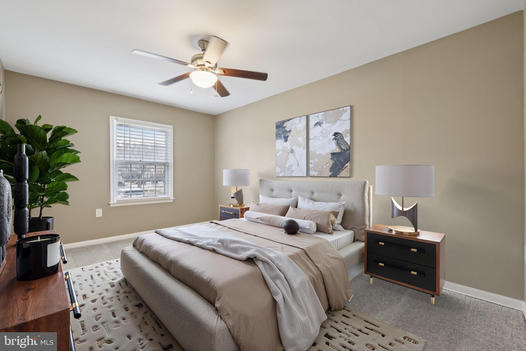 9075 North Laurel Road, Unit E Laurel, MD 20723 - Photo 12 of 20 a bedroom with a large bed and a chandelier