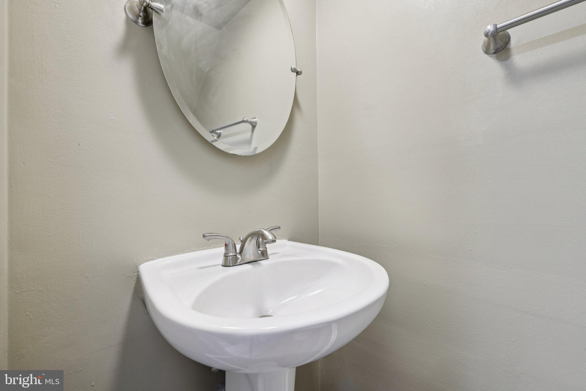 9075 North Laurel Road, Unit E Laurel, MD 20723 - Photo 17 of 20 a bathroom with a sink and mirror