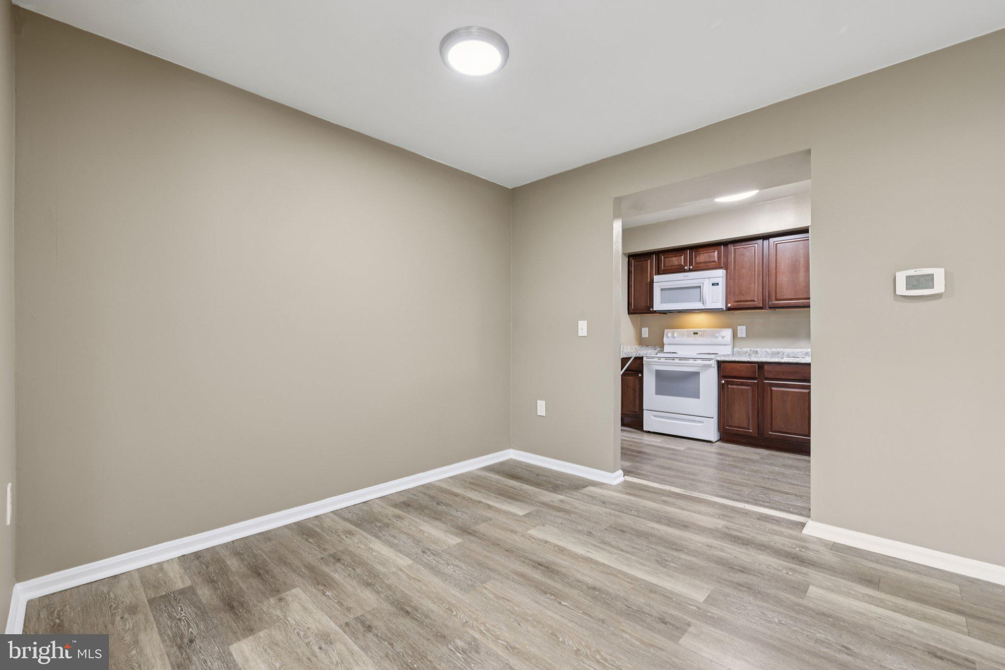9075 North Laurel Road, Unit E Laurel, MD 20723 - Photo 7 of 20 a kitchen with a refrigerator and a stove top oven