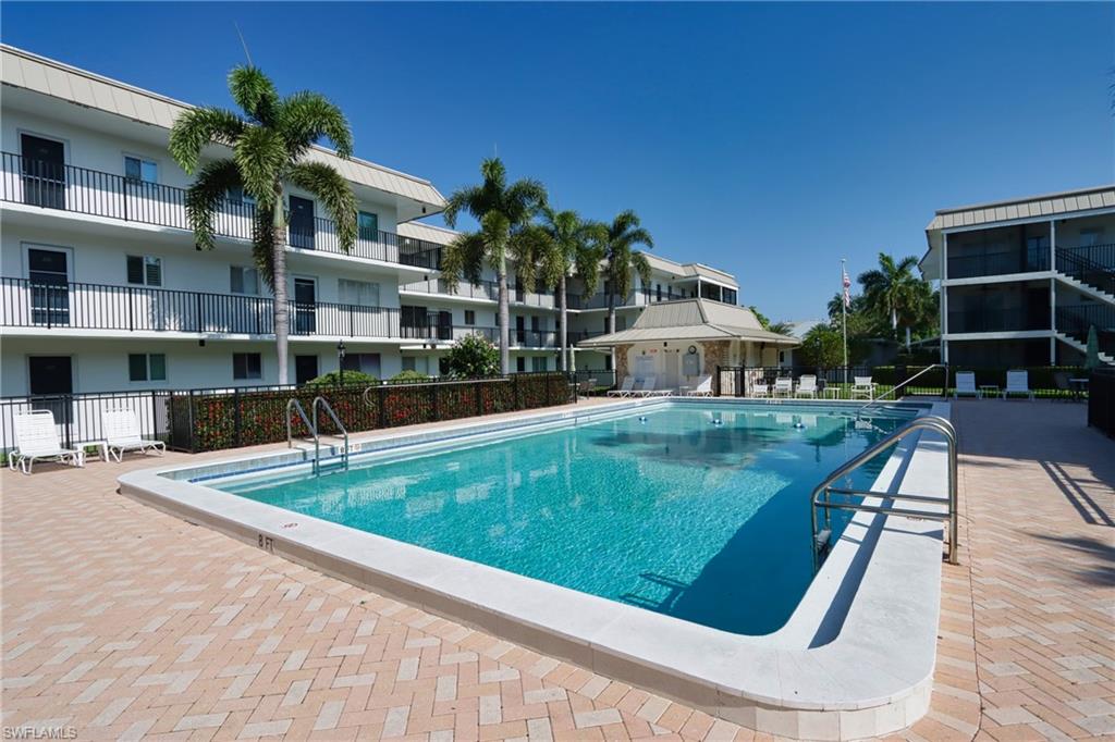 766 Central Avenue, Unit 119 Naples, FL 34102 - Photo 1 of 15 a view of a house with a swimming pool