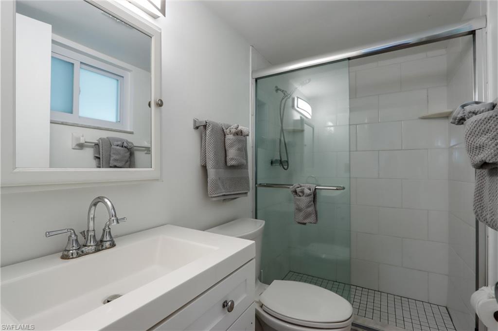 766 Central Avenue, Unit 119 Naples, FL 34102 - Photo 11 of 15 a bathroom with a sink toilet and shower