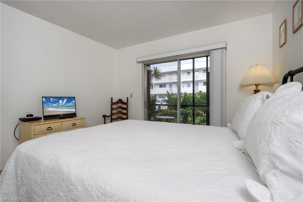 766 Central Avenue, Unit 119 Naples, FL 34102 - Photo 13 of 15 a bed sitting in a bedroom next to a window