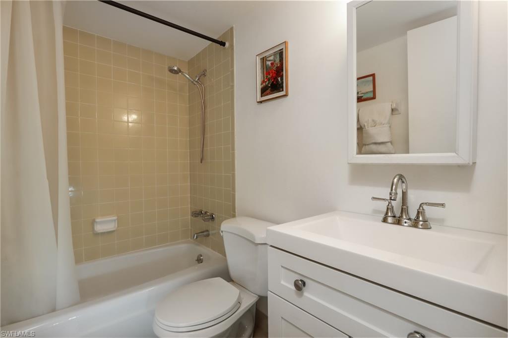 766 Central Avenue, Unit 119 Naples, FL 34102 - Photo 14 of 15 a bathroom with a sink a toilet and shower